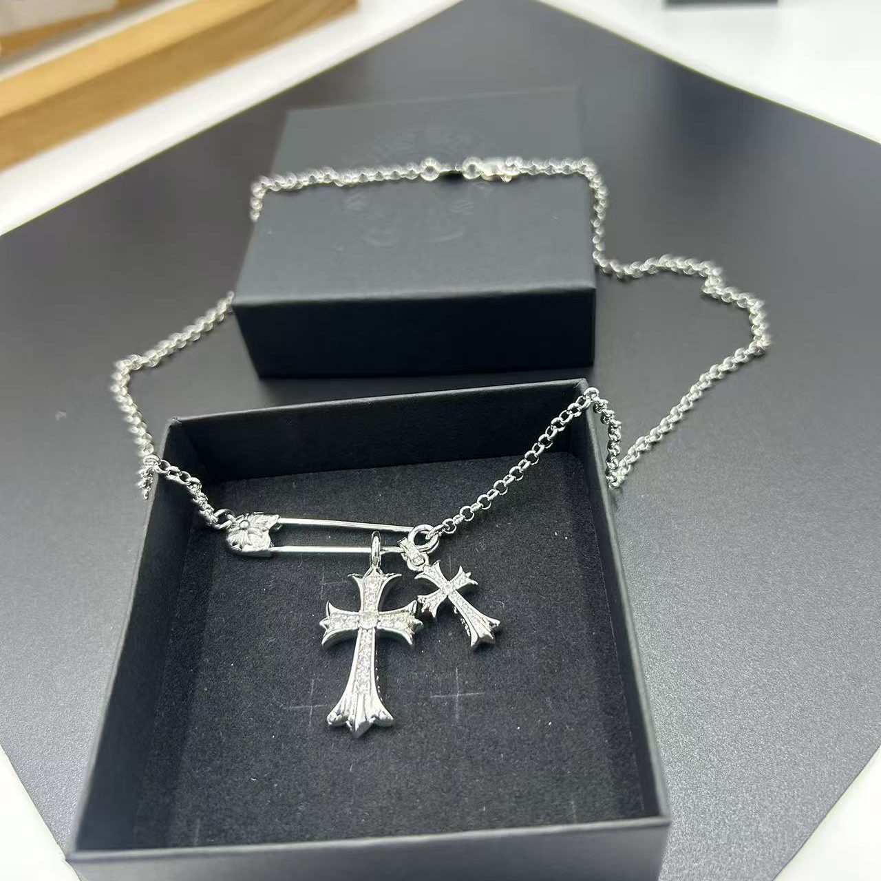 CHROME HEARTS PIN-STYLE DOUBLE CROSS PENDANT NECKLACE WITH FULL RHINESTONE EMBELLISHMENT.