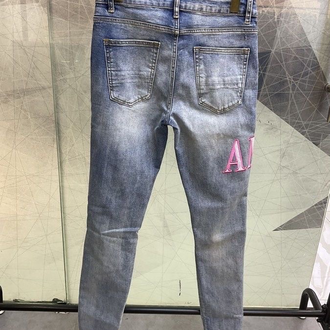 Amiri ripped embroidered logo denim pants