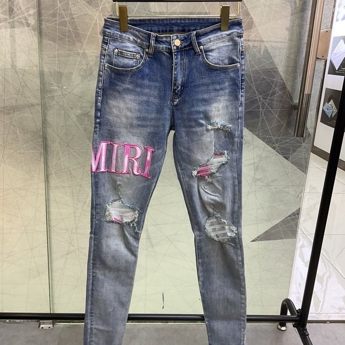 Amiri ripped embroidered logo denim pants
