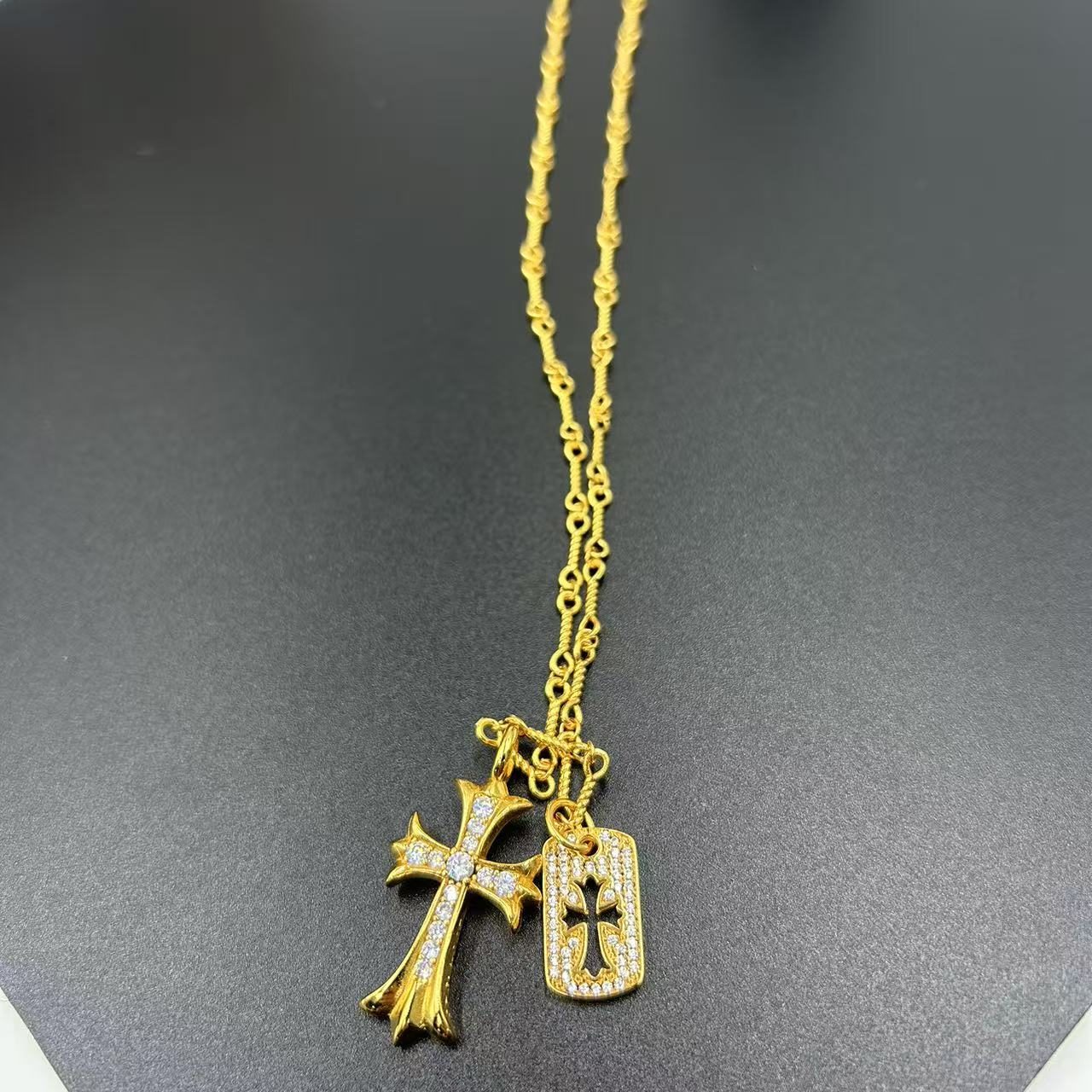 CHROME HEARTS GOLD-PLATED NECKLACE WITH TWO PENDANTS, ENCRUSTED WITH RHINESTONES, DESIGNED FOR LAYERING.