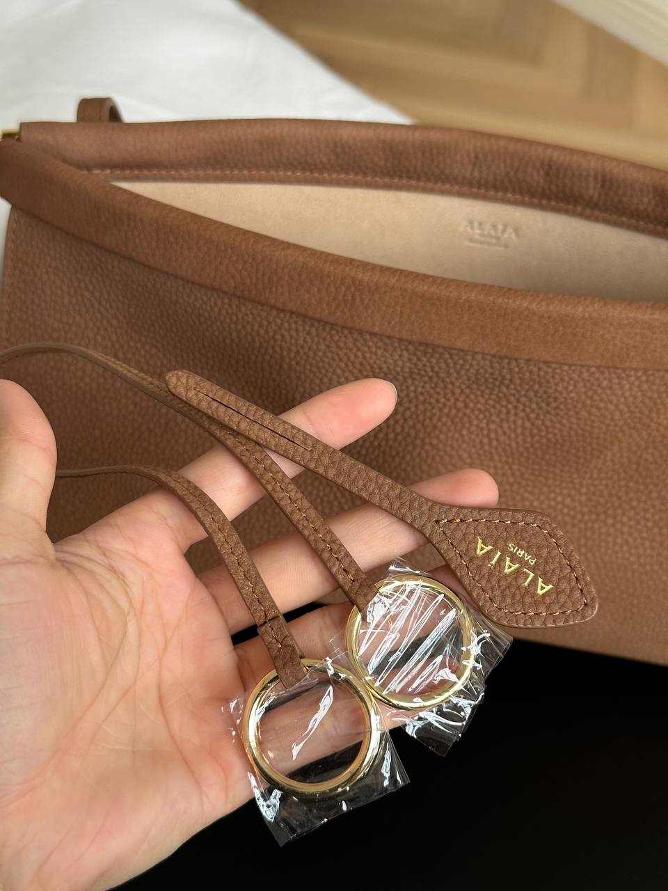 ALAÏA Le Click Medium East-West Pebbled Calfskin Shoulder Bag