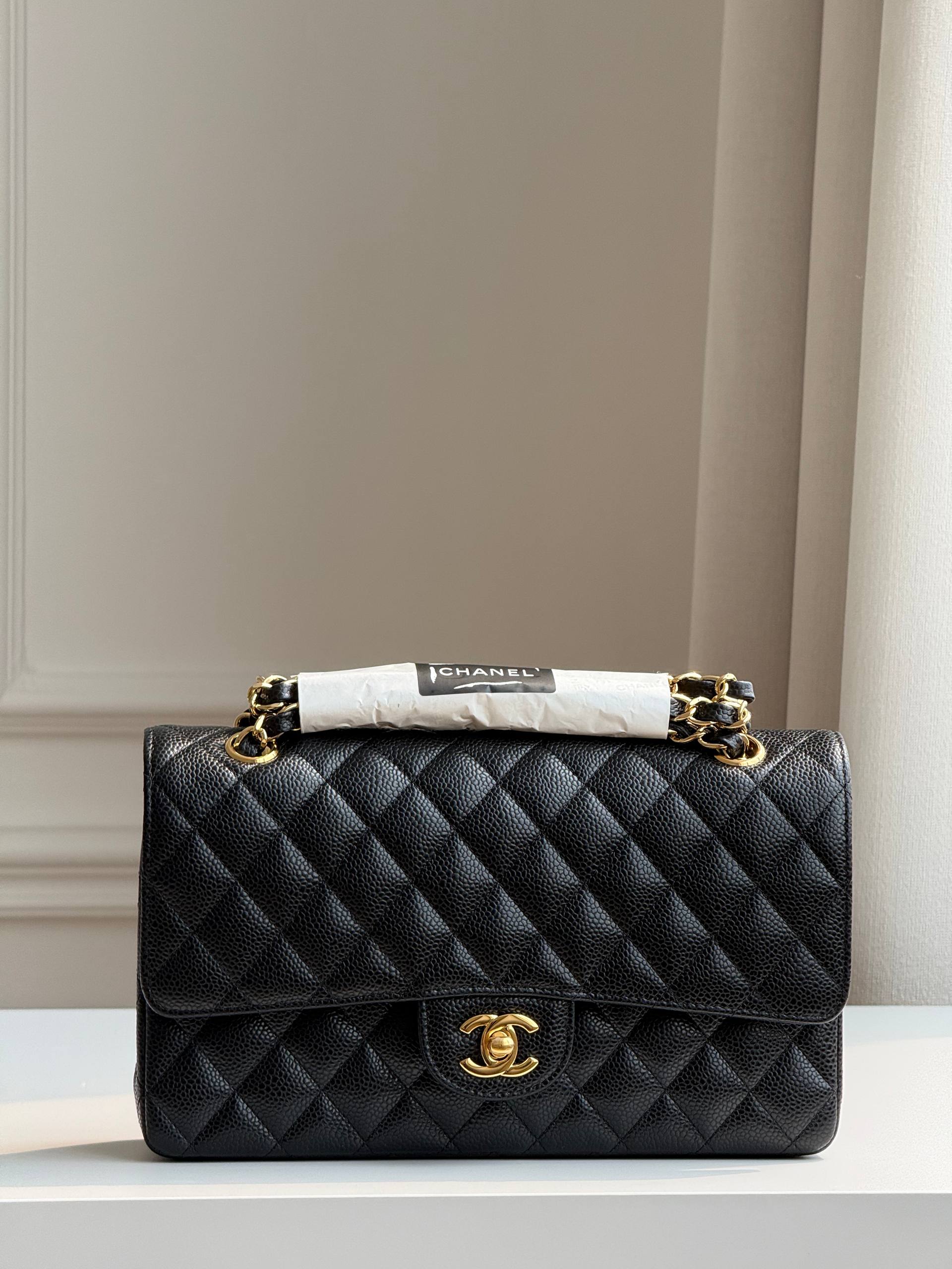 Medium-sized black and gold Chanel CF