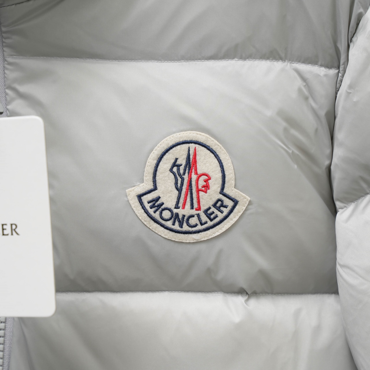 Moncler stand-collar down jacket with a large chest logo