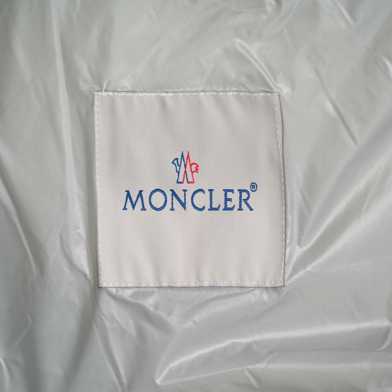 Moncler stand-collar down jacket with a large chest logo
