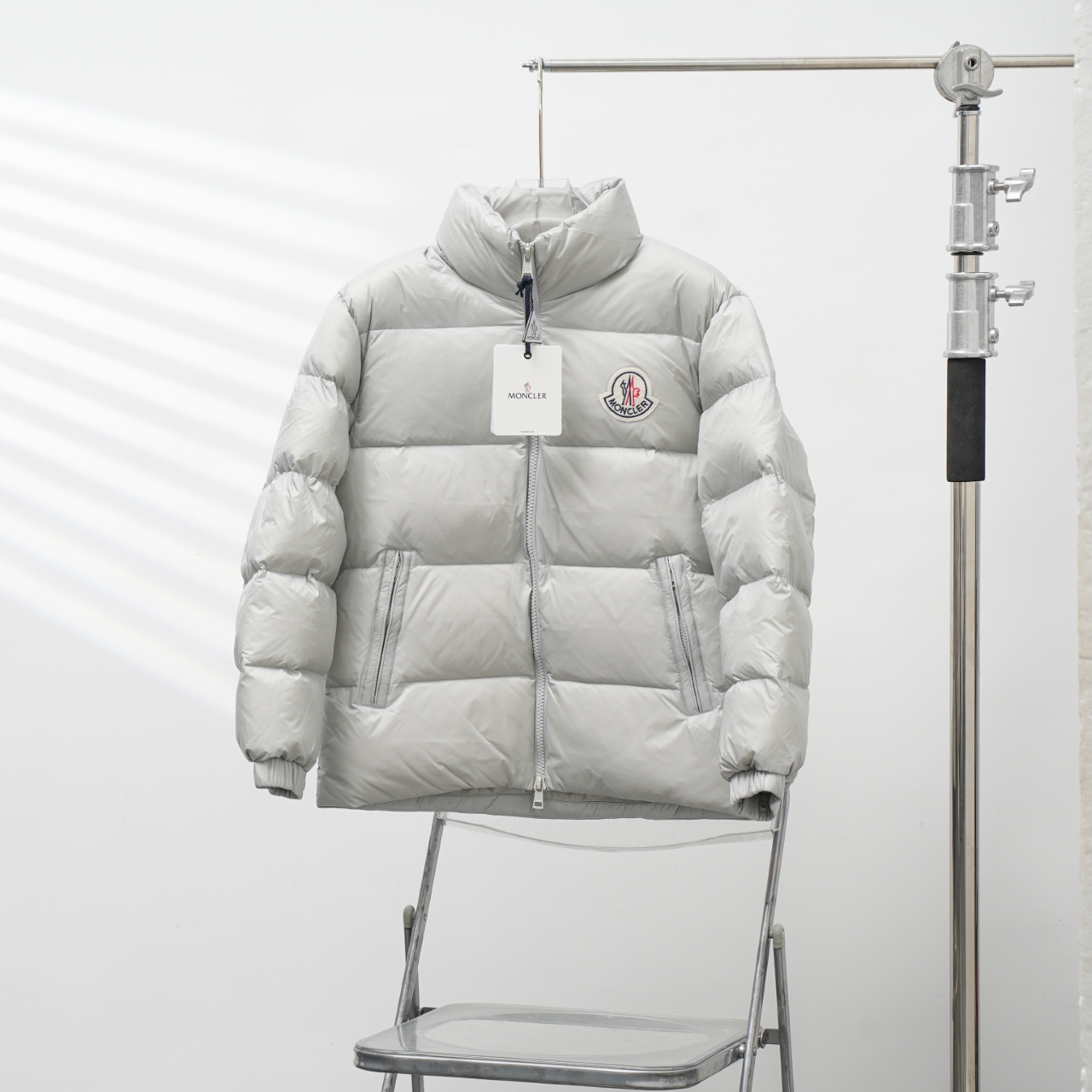 Moncler stand-collar down jacket with a large chest logo
