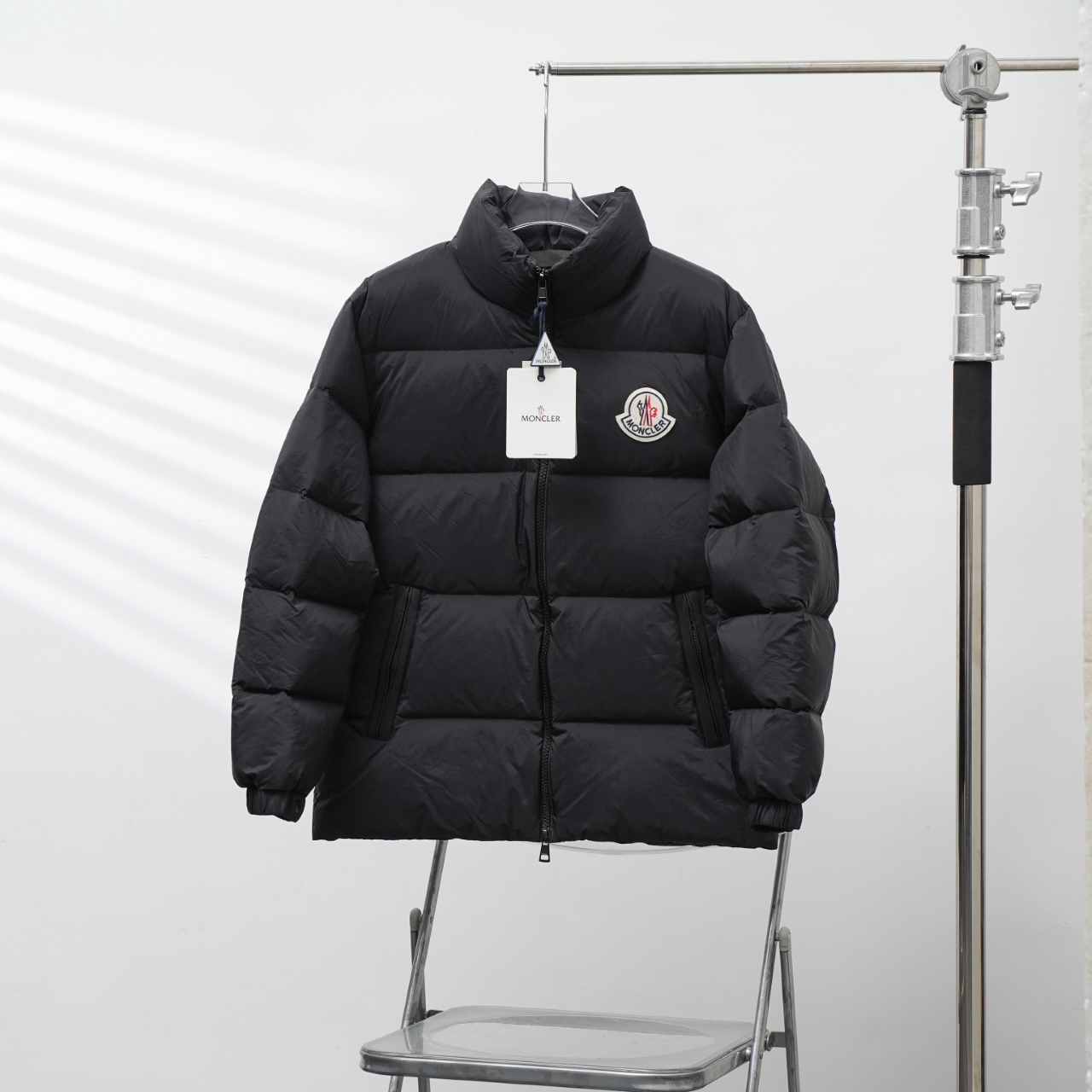 Moncler stand-collar down jacket with a large chest logo