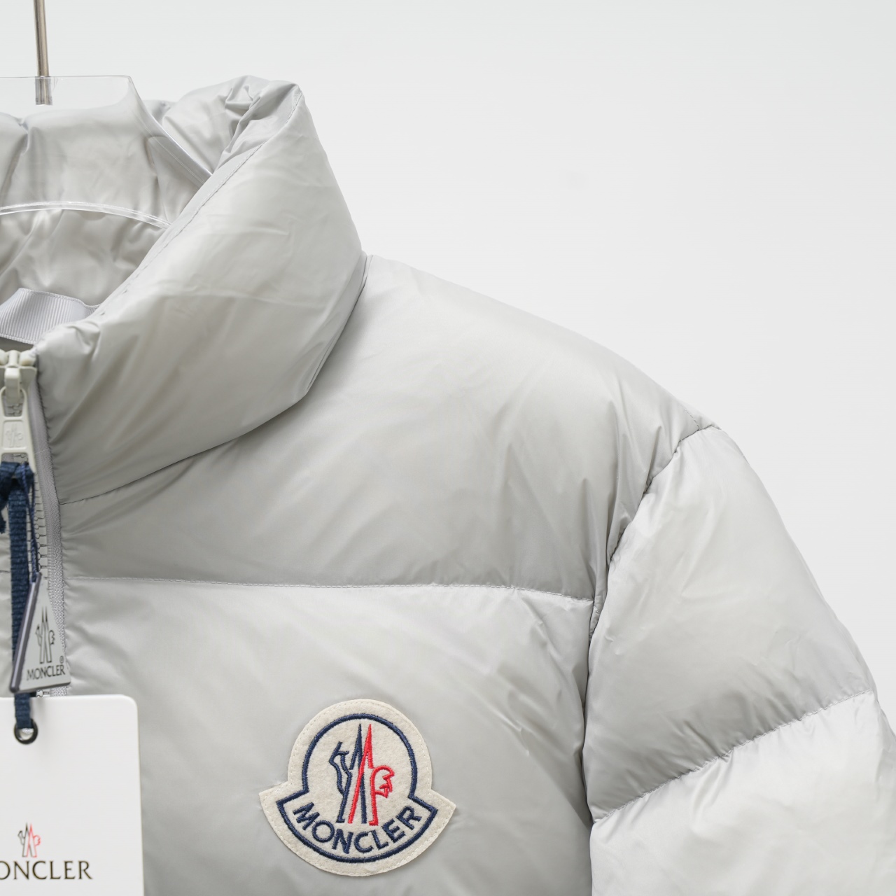 Moncler stand-collar down jacket with a large chest logo